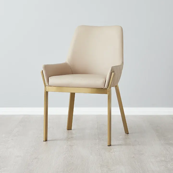 Contemporary Dining Chair covered in sand beige coloured leather fabric with diamond tufted covers., supported by brushed golden coloured stainless steel legs.